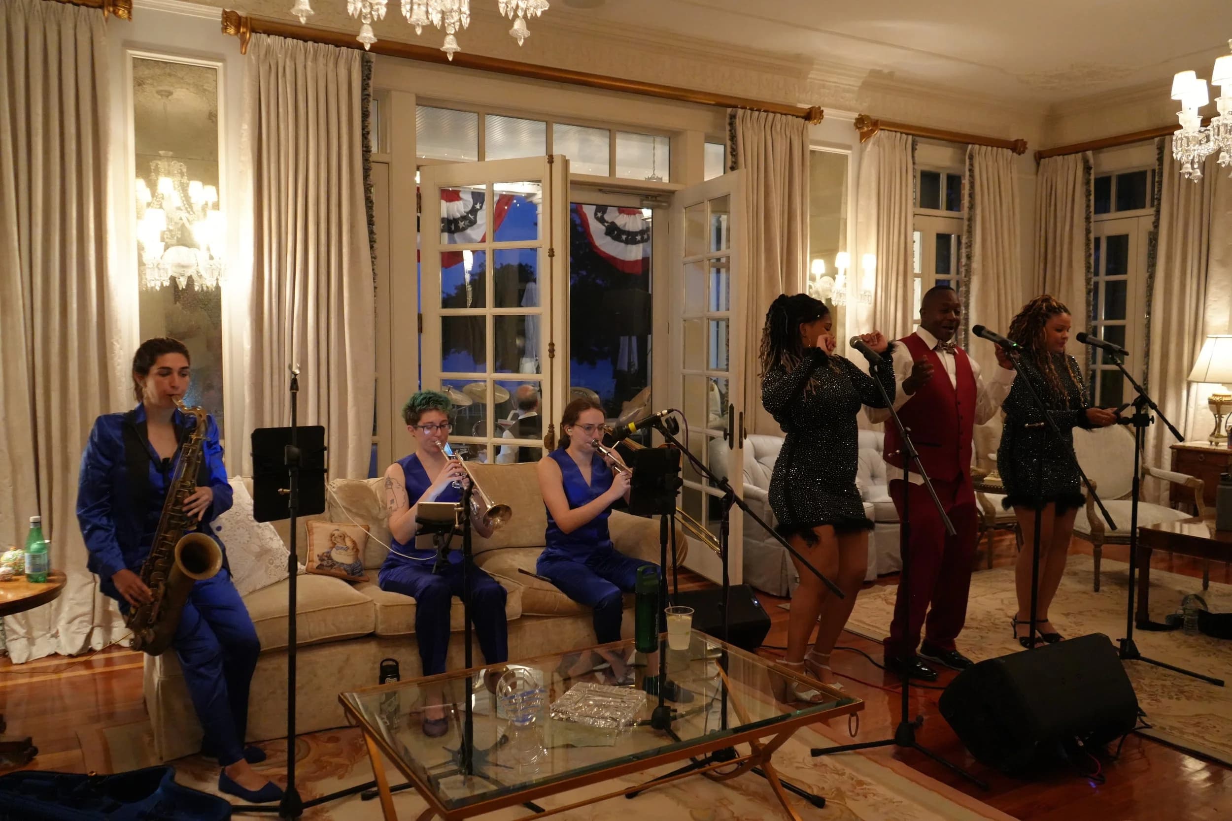 The band with horn section performing in an elegant salon